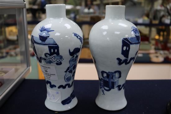 A pair of Chinese blue and white vases, wood stands